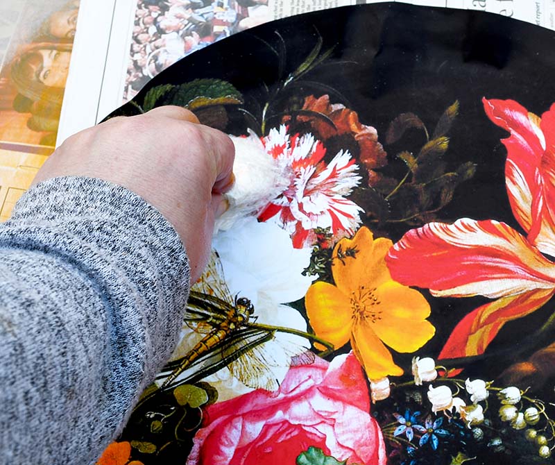 Smoothing out bubbles with flowers decoupage