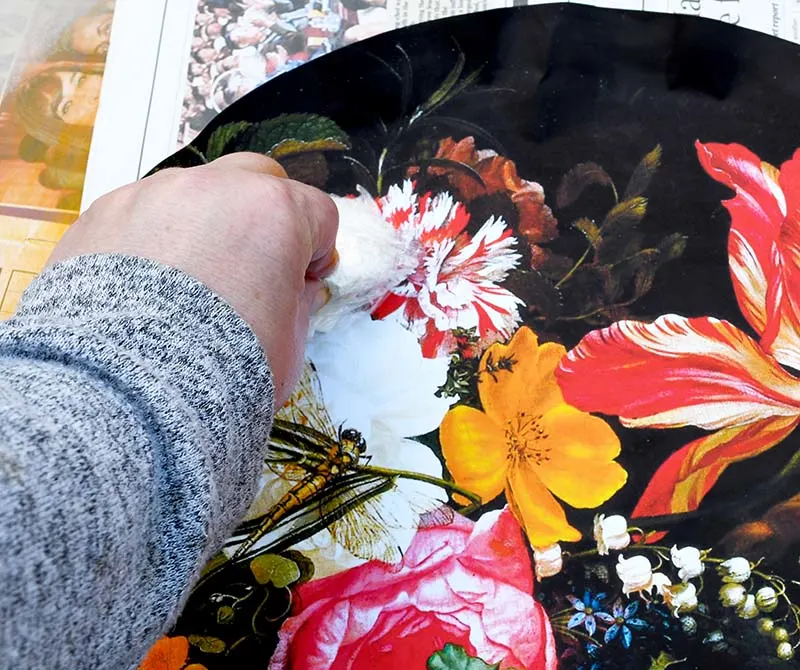 Smoothing out bubbles with flowers decoupage