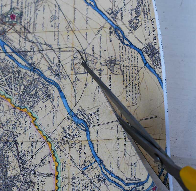 cutting out the map with scissors