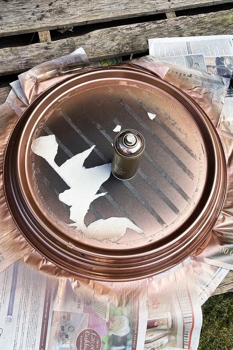 Spraying the clock frame copper.