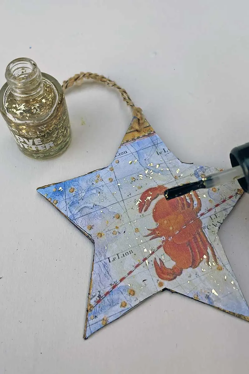 Sealing the diy zodiac Christmas ornament with glitter nail varnish