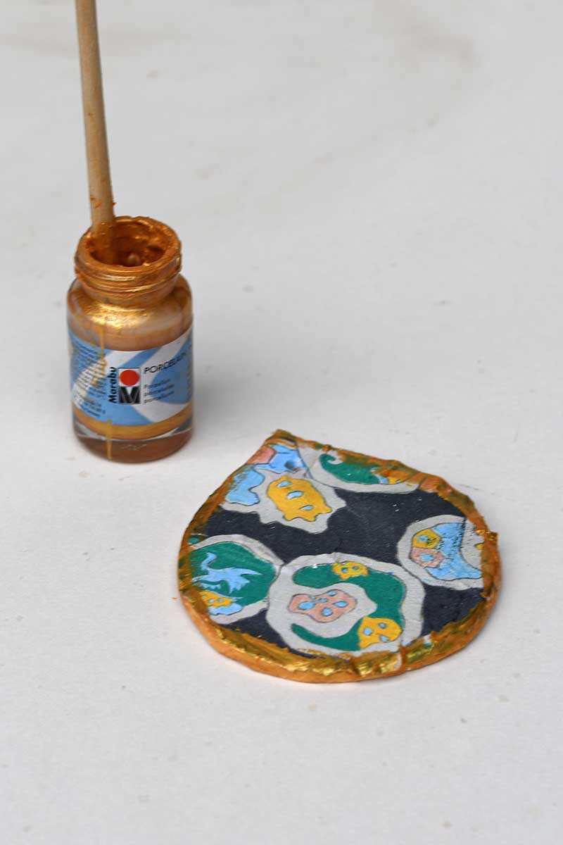 painting the edge of the ornaments with gold paint
