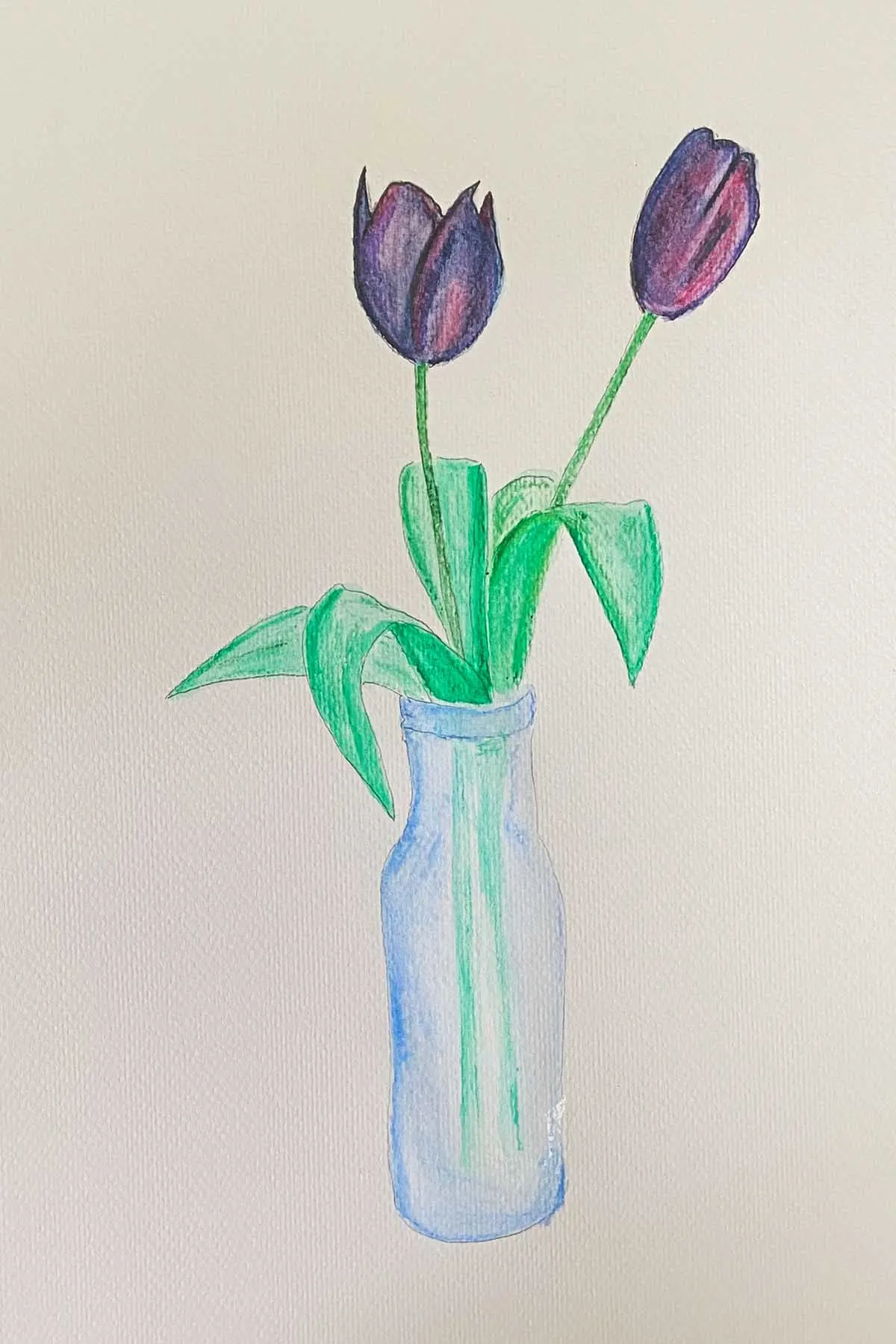 two purple painted tulips in a blue vase