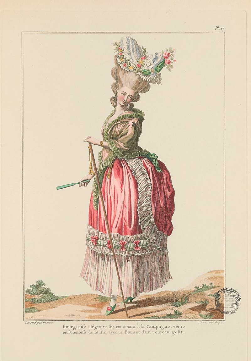 Woman in a pink and green trimmed dress with tall floral headdress, holding a long walking stick outdoors, French Galerie des Modes fashion print 18th century costume illustration
