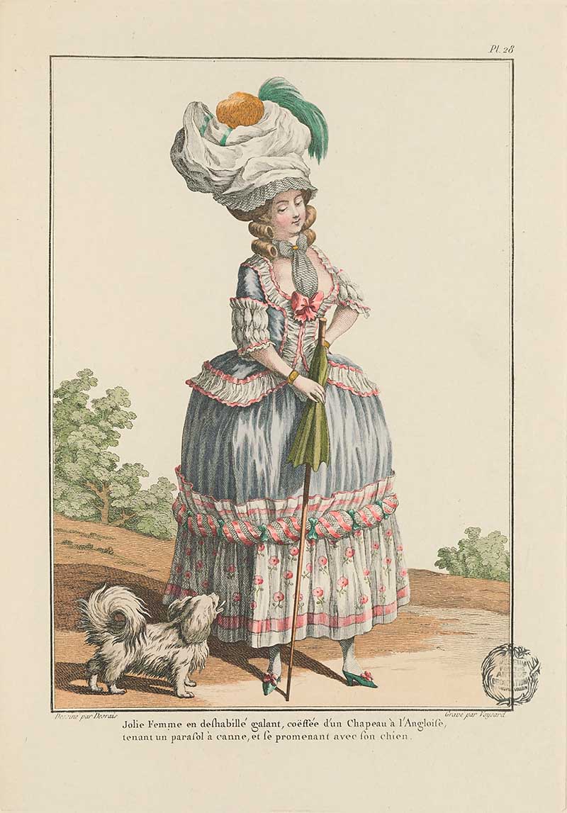 Woman in a blue and floral dress with towering white turban and small dog at her feet in a landscape, French Galerie des Modes fashion print 18th century costume illustration