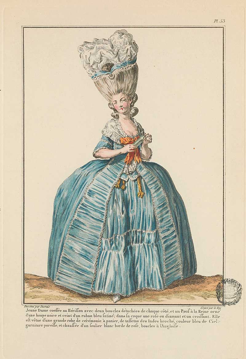 Woman in a voluminous blue gown with white ruffles, orange bow, and towering white headdress standing in profile, French Galerie des Modes fashion print 18th century costume illustration