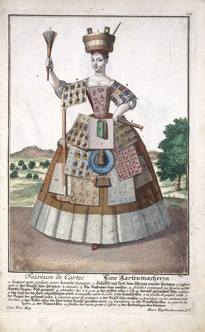 Antique costume print of a female chart maker holding a brush and wearing chart-making tools, with paper, measuring instruments, and map or chart materials on her costume.