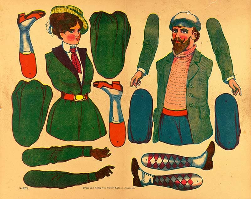German Ziehfiguren cutout sheet of two pull-along figures, a woman in green and a man in a striped shirt, with printed limbs and a boot to assemble