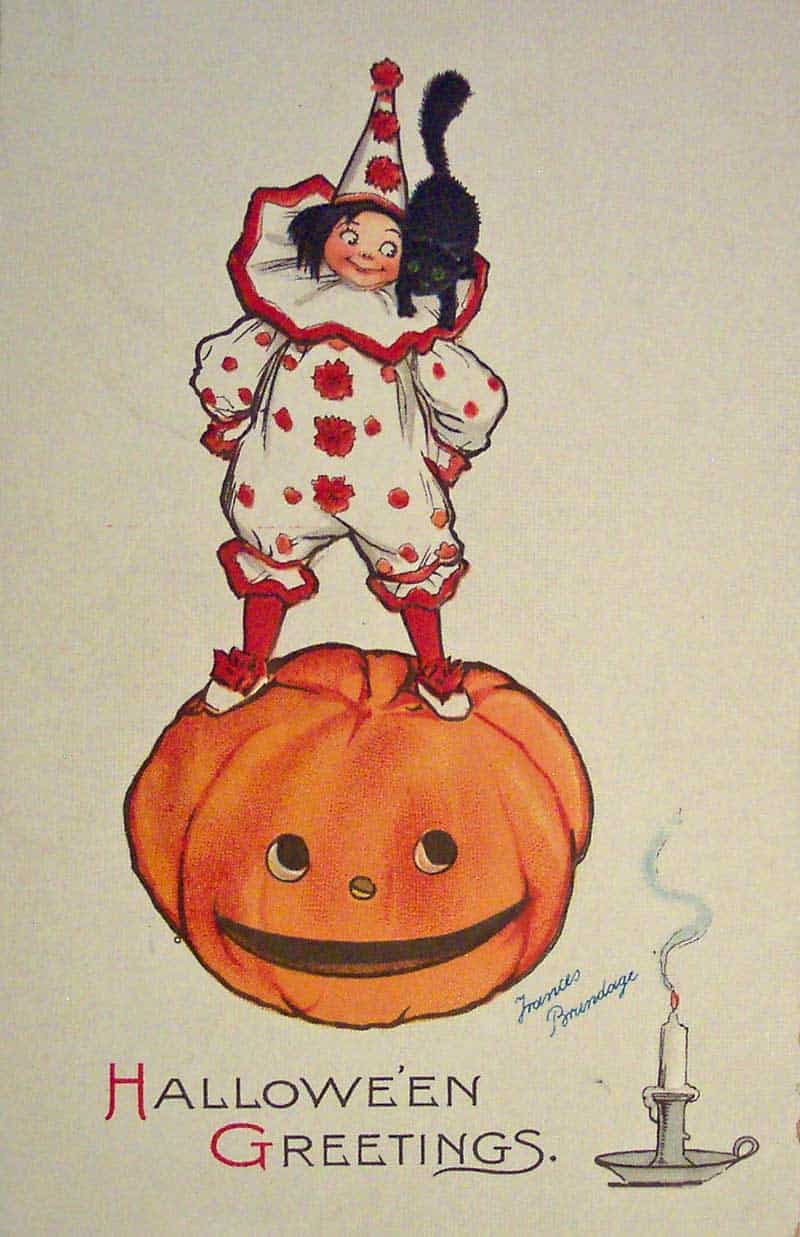 Frances Brundage Halloween Greetings postcard with a clown standing on a smiling pumpkin and holding a black cat.