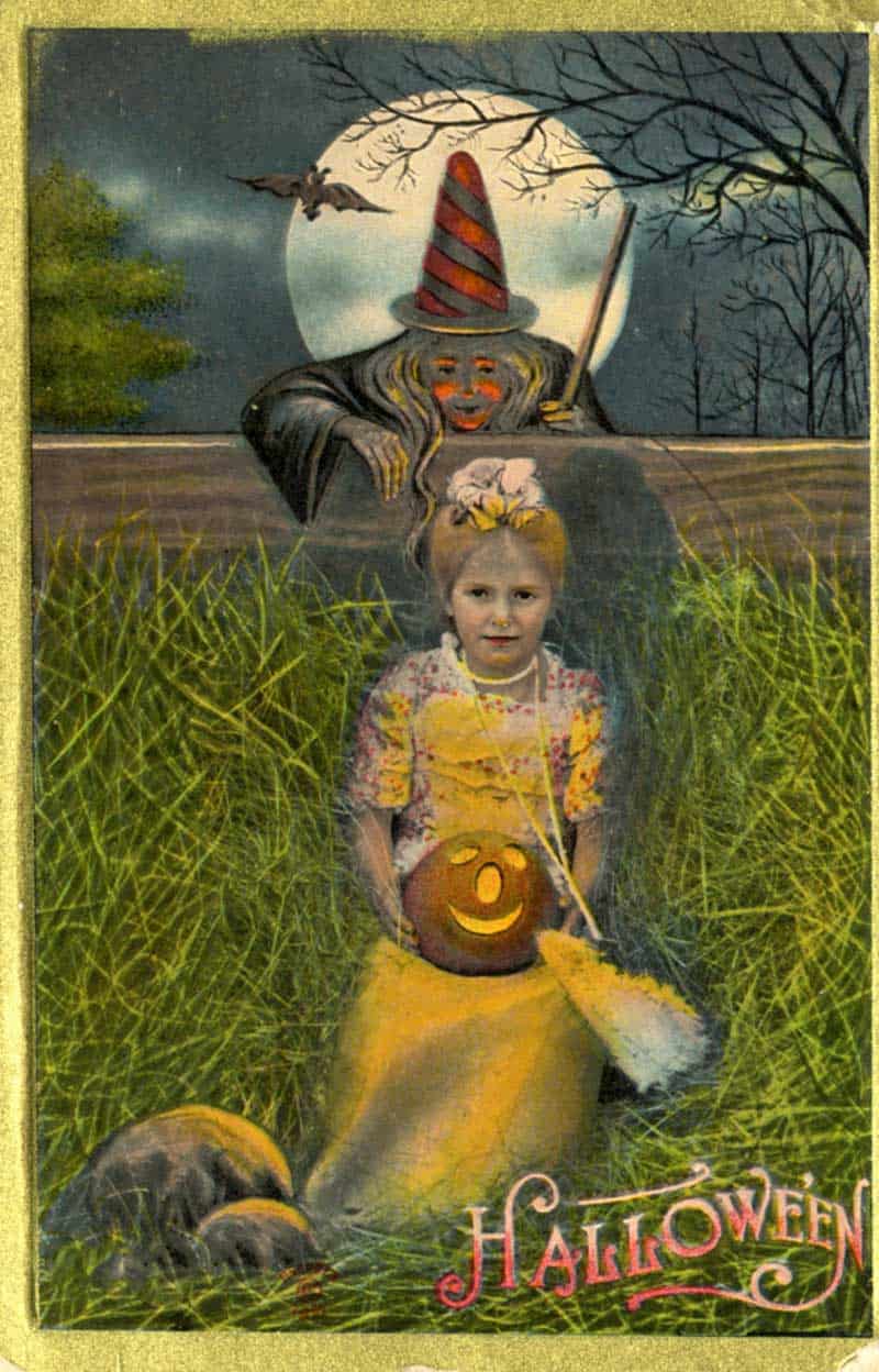 Halloween postcard of a little girl in a haystack with a jack-o’-lantern, witch and bat under a full moon.