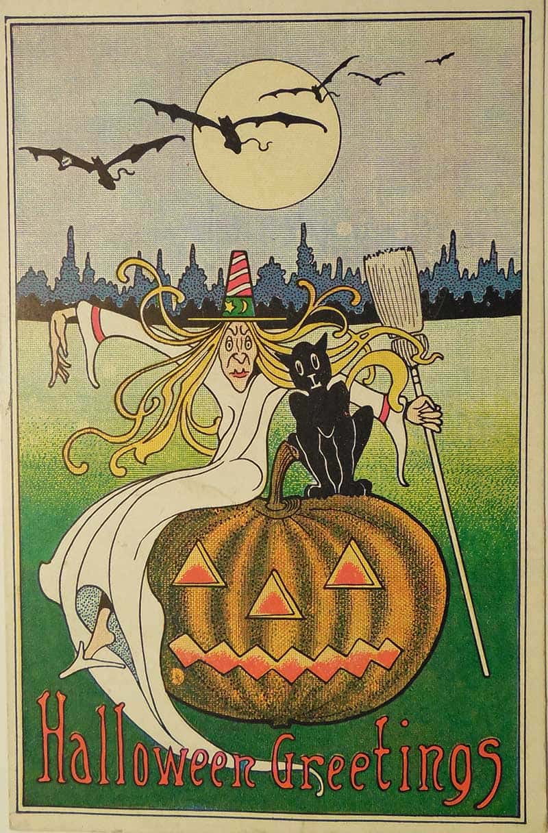 Halloween Greetings postcard with a witch, black cat, bats and jack-o’-lantern under a full moon.