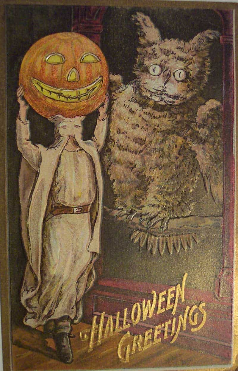 Halloween Greetings postcard with a pumpkin-headed child standing beside a large owl costume figure.